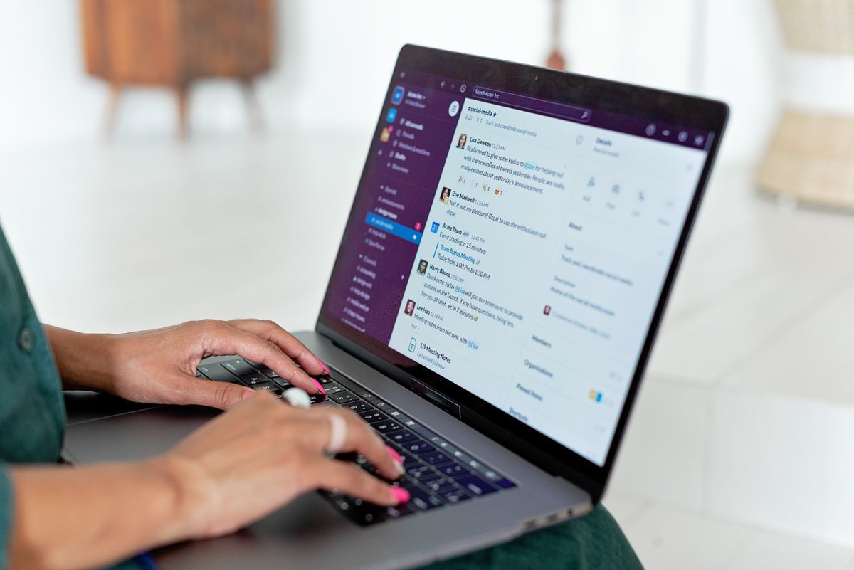 Hands typing on a laptop keyboard